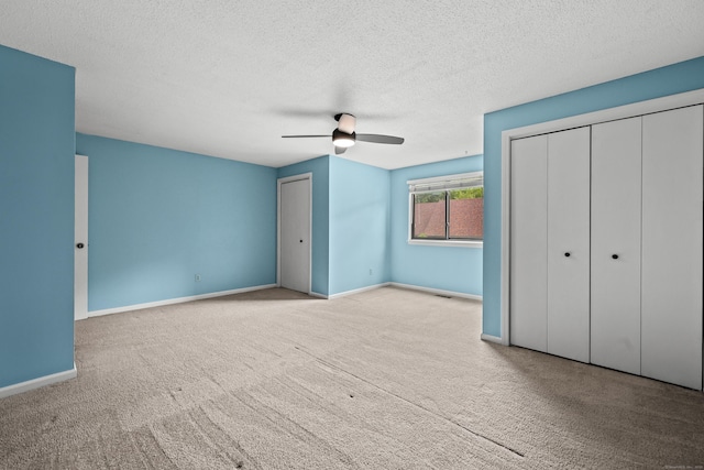 36 Wood Duck Ln Unit 36, Simsbury, CT 06081 - unfurnished bedroom featuring carpet floors, a textured ceiling, baseboards, and ceiling fan