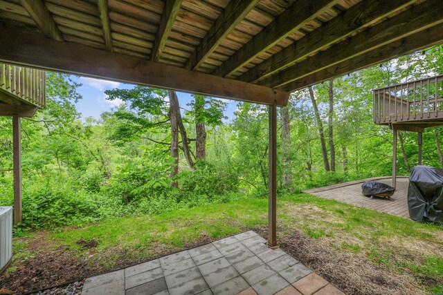 36 Wood Duck Ln Unit 36, Simsbury, CT 06081 - view of patio with a grill, a wooden deck, a view of trees, and an outdoor fire pit