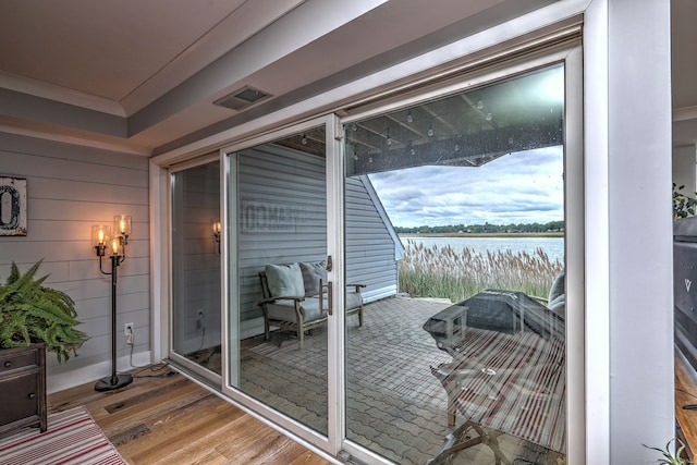 714 Popes Island Rd Unit 714, Milford, CT 06461 - doorway with wood finished floors, a water view, and ornamental molding