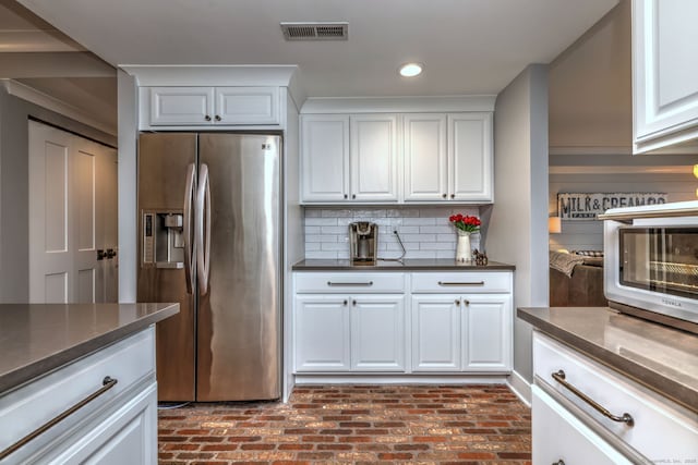 714 Popes Island Rd Unit 714, Milford, CT 06461 - kitchen with stainless steel fridge, brick floors, white cabinetry, recessed lighting, and backsplash
