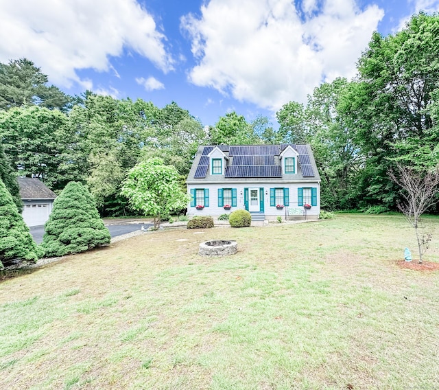 523 Wauregan Rd, Killingly, CT 06239 - view of front facade with roof mounted solar panels, a front lawn, and a fire pit