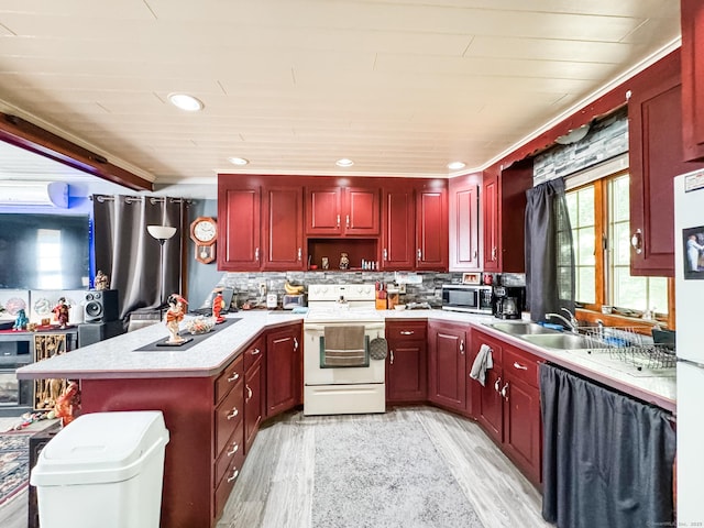 523 Wauregan Rd, Killingly, CT 06239 - kitchen featuring electric range, dark brown cabinets, stainless steel microwave, a sink, and light wood-type flooring