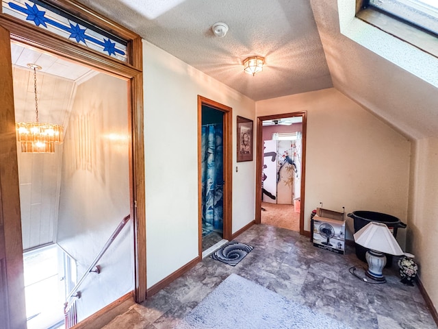 523 Wauregan Rd, Killingly, CT 06239 - foyer featuring a chandelier, baseboards, lofted ceiling, and a textured ceiling