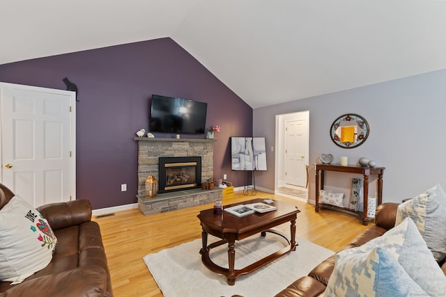 19 Ridgeview Dr, Ellington, CT 06029 - living area featuring vaulted ceiling, wood finished floors, a stone fireplace, and baseboards