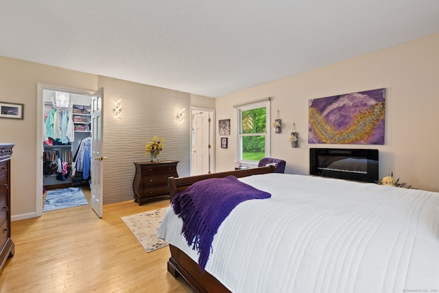 19 Ridgeview Dr, Ellington, CT 06029 - bedroom featuring light wood-style floors, a walk in closet, and a closet