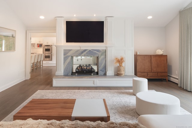 50 Parish Rd N, New Canaan, CT 06840 - living room with wood finished floors, a baseboard radiator, baseboards, and recessed lighting
