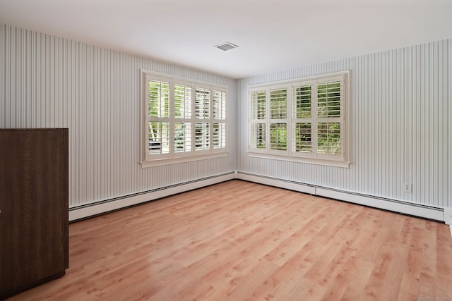 50 Parish Rd N, New Canaan, CT 06840 - empty room with wood finished floors, plenty of natural light, and a baseboard heating unit
