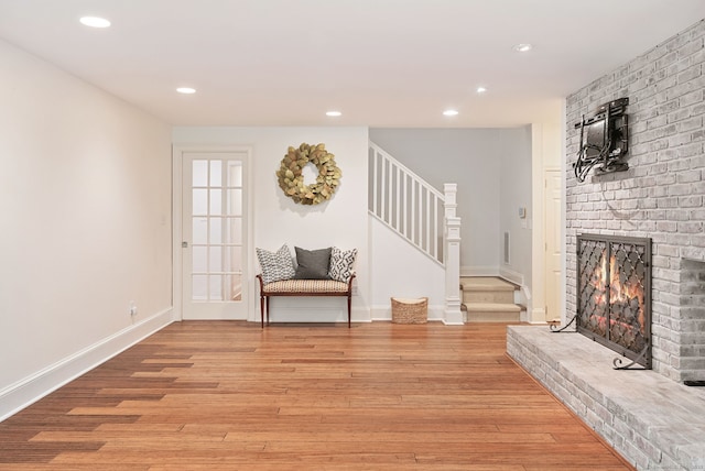 50 Parish Rd N, New Canaan, CT 06840 - sitting room featuring light wood finished floors, stairway, a brick fireplace, recessed lighting, and baseboards