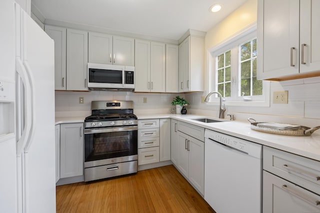 25 Hamden Hills Dr Unit 60, Hamden, CT 06518 - kitchen with white appliances, a sink, backsplash, light countertops, and recessed lighting