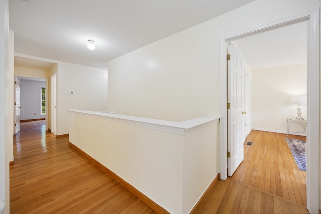 25 Hamden Hills Dr Unit 60, Hamden, CT 06518 - hallway with light wood-type flooring, baseboards, and an upstairs landing