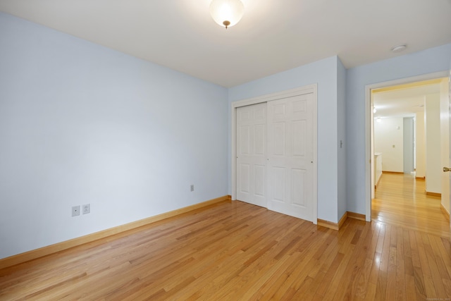 25 Hamden Hills Dr Unit 60, Hamden, CT 06518 - unfurnished bedroom with light wood finished floors, a closet, and baseboards