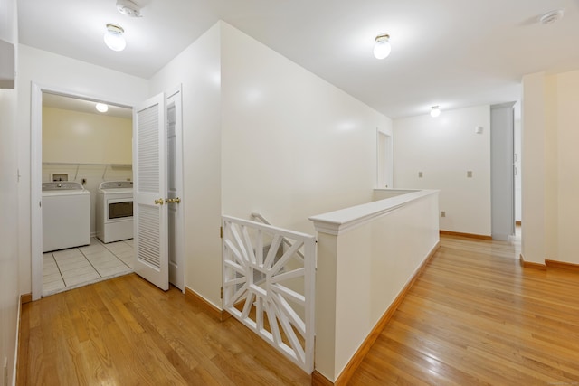 25 Hamden Hills Dr Unit 60, Hamden, CT 06518 - corridor with washing machine and clothes dryer, light wood-style flooring, an upstairs landing, and baseboards