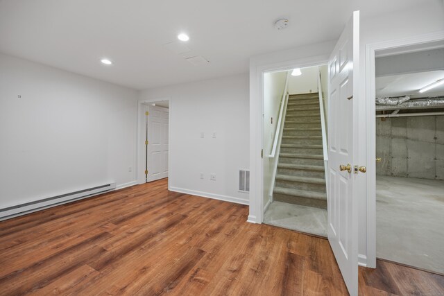 25 Hamden Hills Dr Unit 60, Hamden, CT 06518 - below grade area with stairway, wood finished floors, baseboard heating, and recessed lighting