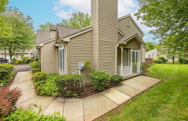 25 Hamden Hills Dr Unit 60, Hamden, CT 06518 - view of property exterior with a chimney, a yard, and roof with shingles