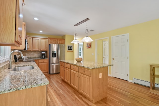 22 Gelding Hill Rd, Newtown, CT 06482 - kitchen featuring stainless steel fridge, a sink, light wood-style flooring, a center island, and light stone counters