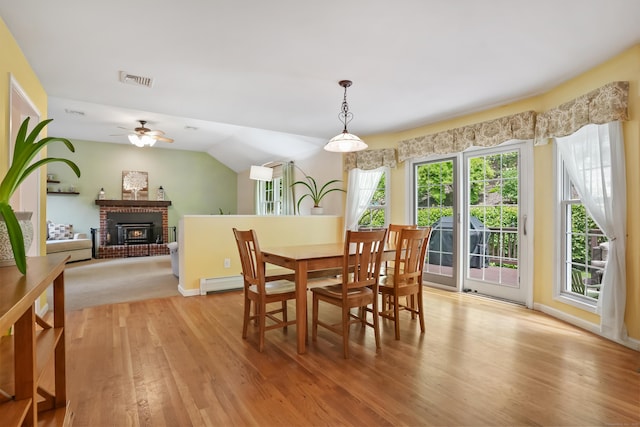 22 Gelding Hill Rd, Newtown, CT 06482 - dining area with light wood finished floors, baseboard heating, a ceiling fan, a brick fireplace, and baseboards