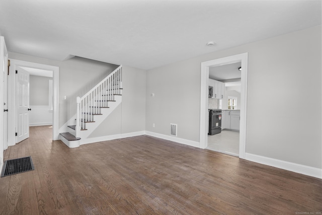 330 Meriden Ave, Southington, CT 06489 - unfurnished living room with stairway, wood finished floors, and baseboards