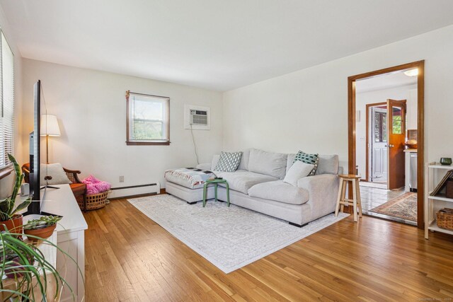 64 Willow St, Milford, CT 06460 - living room with a baseboard heating unit, light wood-style flooring, and a wall mounted air conditioner
