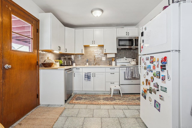 64 Willow St, Milford, CT 06460 - kitchen featuring stainless steel appliances, a sink, light countertops, backsplash, and white cabinets
