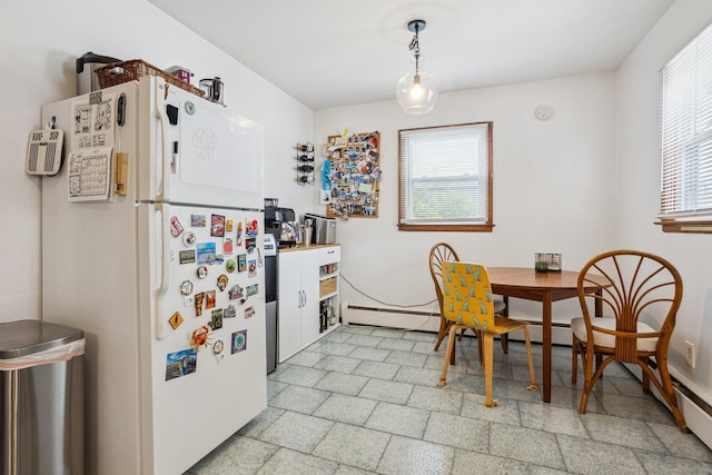 64 Willow St, Milford, CT 06460 - kitchen with freestanding refrigerator, baseboards, hanging light fixtures, and a baseboard heating unit