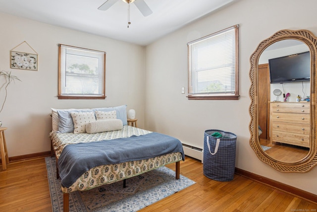 64 Willow St, Milford, CT 06460 - bedroom featuring multiple windows, light wood-type flooring, a baseboard heating unit, and baseboards
