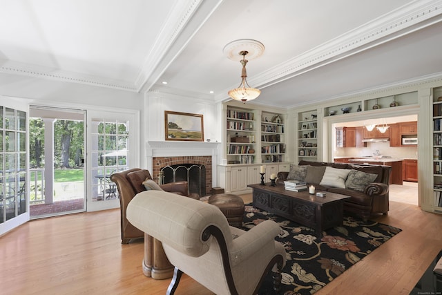 52 Dug Rd, Glastonbury, CT 06073 - living room with ornamental molding, light wood-type flooring, and a fireplace