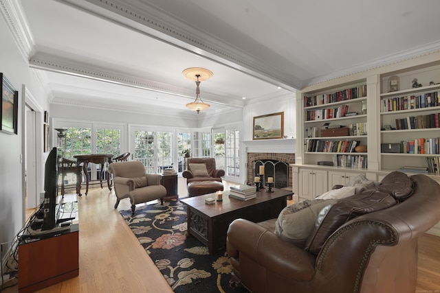 52 Dug Rd, Glastonbury, CT 06073 - living area with ornamental molding, wood finished floors, plenty of natural light, and a fireplace