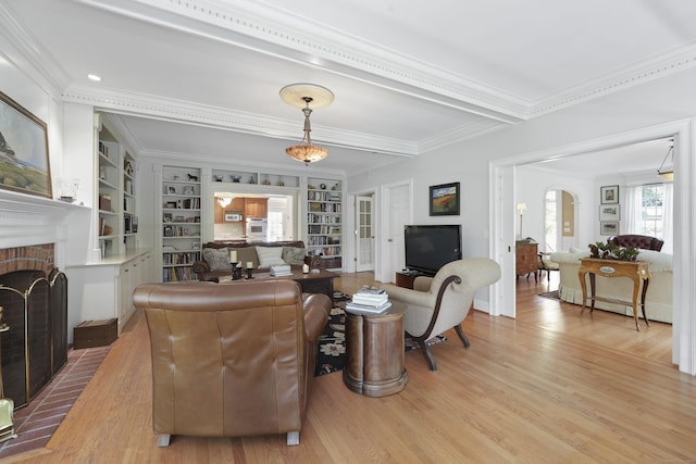 52 Dug Rd, Glastonbury, CT 06073 - living room featuring a fireplace, crown molding, light wood-style flooring, and built in features