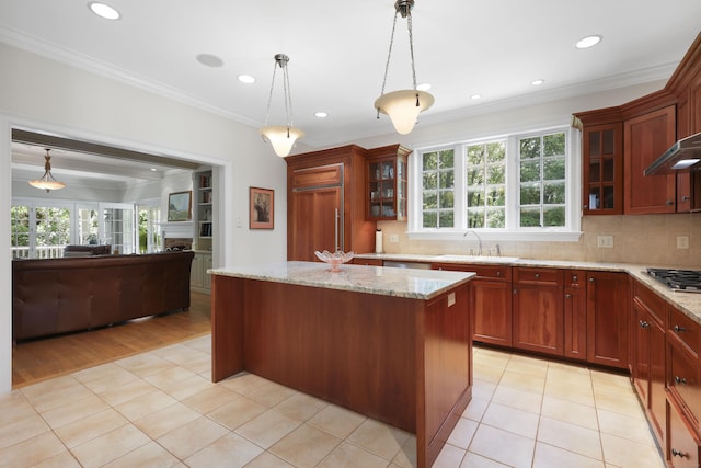 52 Dug Rd, Glastonbury, CT 06073 - kitchen featuring ornamental molding, stainless steel gas stovetop, a center island, hanging light fixtures, and a sink