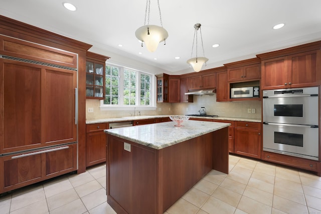 52 Dug Rd, Glastonbury, CT 06073 - kitchen featuring appliances with stainless steel finishes, under cabinet range hood, ornamental molding, glass insert cabinets, and a center island