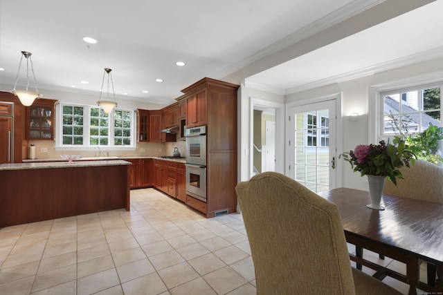 52 Dug Rd, Glastonbury, CT 06073 - kitchen with double oven, ornamental molding, plenty of natural light, light tile patterned flooring, and glass insert cabinets