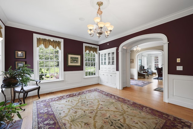 52 Dug Rd, Glastonbury, CT 06073 - foyer with a chandelier, healthy amount of natural light, arched walkways, wood finished floors, and crown molding