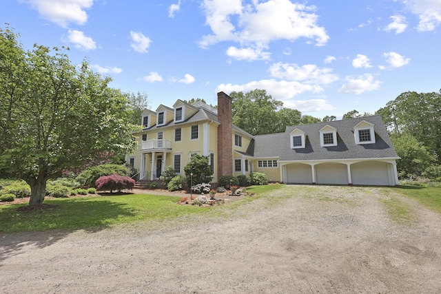 52 Dug Rd, Glastonbury, CT 06073 - view of front of house with driveway, a chimney, a front yard, a shingled roof, and a garage