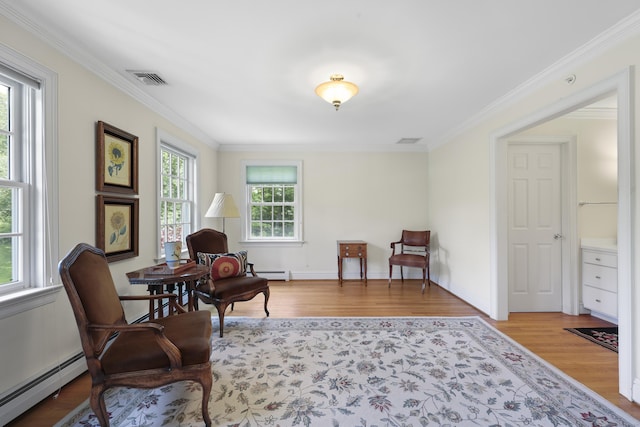 52 Dug Rd, Glastonbury, CT 06073 - living area featuring a baseboard heating unit, wood finished floors, crown molding, and baseboards