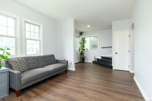 163 State Ave, Killingly, CT 06241 - living area with dark wood finished floors, stairway, arched walkways, a baseboard heating unit, and recessed lighting