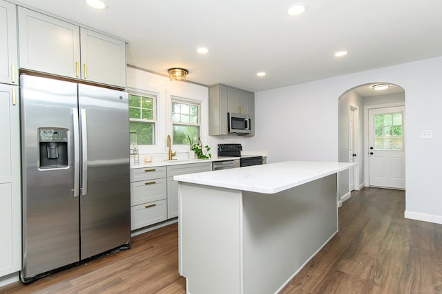 163 State Ave, Killingly, CT 06241 - kitchen with stainless steel appliances, arched walkways, dark wood-style flooring, recessed lighting, and gray cabinets