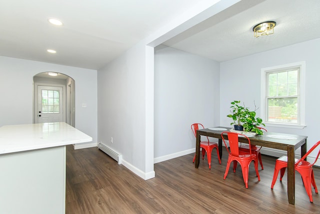 163 State Ave, Killingly, CT 06241 - dining room featuring baseboard heating, arched walkways, dark wood-type flooring, and recessed lighting