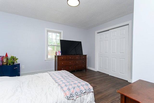 163 State Ave, Killingly, CT 06241 - bedroom with dark wood-style flooring, a closet, a textured ceiling, and a baseboard radiator