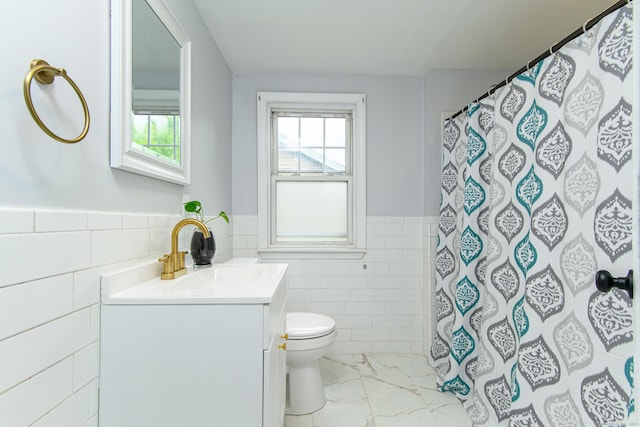 163 State Ave, Killingly, CT 06241 - full bathroom with tile walls, marble finish flooring, vanity, a wainscoted wall, and curtained shower
