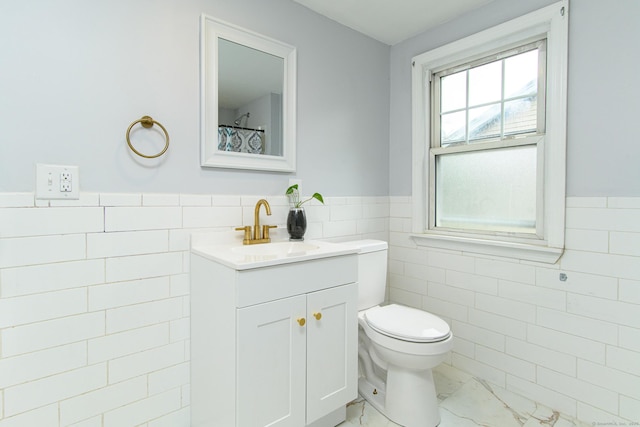 163 State Ave, Killingly, CT 06241 - bathroom featuring tile walls, marble finish floors, wainscoting, and vanity