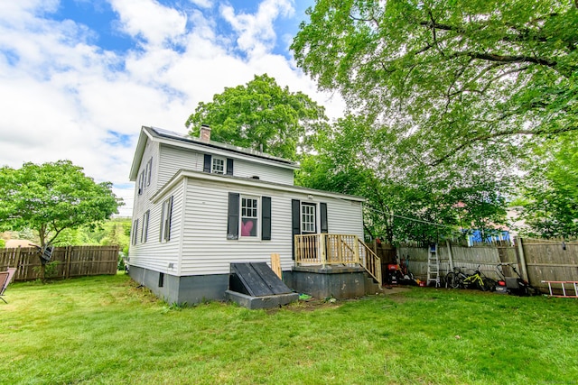 163 State Ave, Killingly, CT 06241 - back of house with a chimney and a fenced backyard