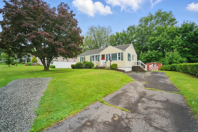 19 Litchfield Pl, Rocky Hill, CT 06067 - view of front of home with a storage shed, driveway, and a front yard