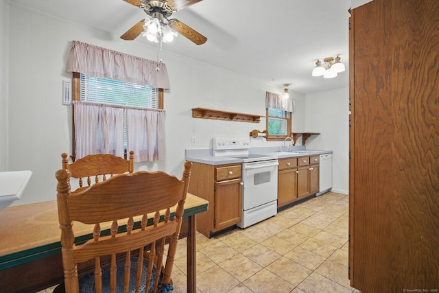 19 Litchfield Pl, Rocky Hill, CT 06067 - kitchen featuring white appliances, ceiling fan, brown cabinetry, light tile patterned floors, and light countertops
