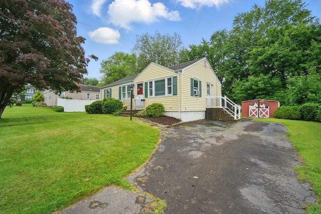 19 Litchfield Pl, Rocky Hill, CT 06067 - view of front of home with a storage unit and asphalt driveway