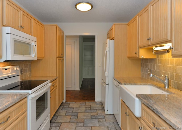 881 Heritage Vlg Unit B, Southbury, CT 06488 - kitchen with white appliances, a sink, light stone finish floors, light brown cabinetry, and a textured ceiling