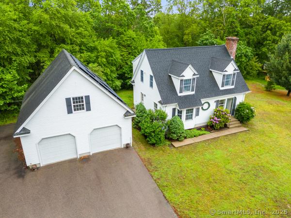 5 Conrad Ct, Ledyard, CT 06335 - view of front of property with a chimney, a front yard, and driveway