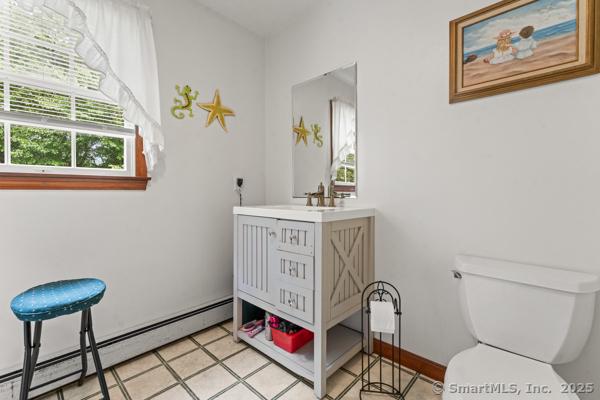 5 Conrad Ct, Ledyard, CT 06335 - half bath featuring baseboard heating, toilet, vanity, and tile patterned flooring