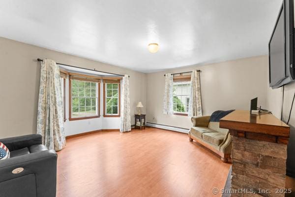 5 Conrad Ct, Ledyard, CT 06335 - sitting room featuring baseboard heating, wood finished floors, and baseboards