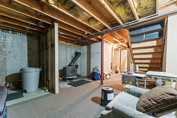 5 Conrad Ct, Ledyard, CT 06335 - unfinished below grade area featuring a wood stove