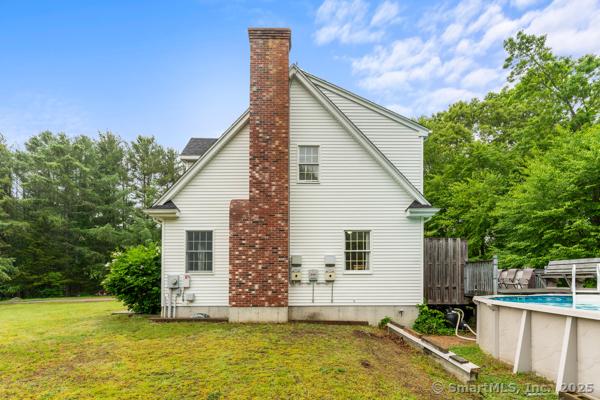 5 Conrad Ct, Ledyard, CT 06335 - view of home's exterior with an outdoor pool and a chimney